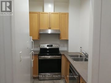 Toronto (Church-Yonge Corridor) condo for rent - A kitchen with wooden cabinets and stainless steel appliances.