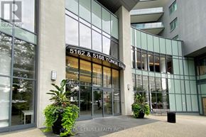 Toronto (Willowdale West) condo for rent - The building is a modern structure with glass windows and doors.
