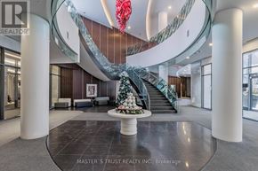 Toronto (Willowdale West) condo for rent - A large atrium with a Christmas tree and a staircase with a glass railing.