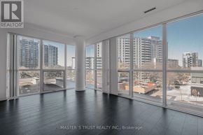 Toronto (Willowdale West) condo for rent - A room with a view of the cityscape through large windows.