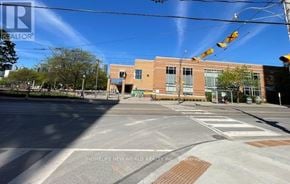 Toronto (Regent Park) condo for rent - A street view with a building and a sign that says "REALTOR".