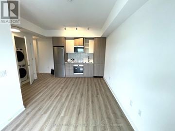 Toronto (Regent Park) condo for rent - A spacious kitchen with wooden flooring and modern appliances.