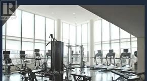 Toronto (Islington-City Centre West) condo for rent - A gym with a row of treadmills and a row of stationary bikes.