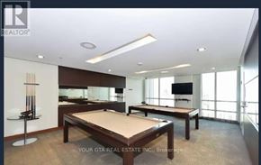 Toronto (Islington-City Centre West) condo for rent - A billiard table is in the middle of a room with a pool table and a TV.