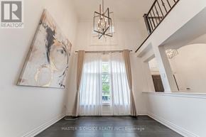 Oakville (Jc Joshua Creek) apartment for rent - A large, empty room with a chandelier and a painting on the wall.