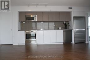 Toronto (Waterfront Communities) condo for rent - A modern kitchen with a stainless steel refrigerator and oven.