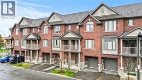 Hamilton townhouse for rent - A large red brick building with a balcony on the second floor.