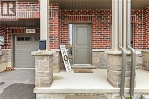 Hamilton townhouse for rent - A house with a sign that says "HOME" in front of it.