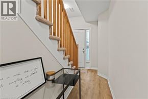 Hamilton townhouse for rent - A hallway with a glass table and a framed quote on it.