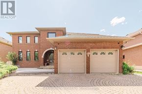 Vaughan (East Woodbridge) apartment for rent - A brick house with a garage door and a driveway.