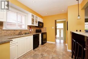 Toronto (Woburn) apartment for rent - A kitchen with yellow walls and white cabinets.