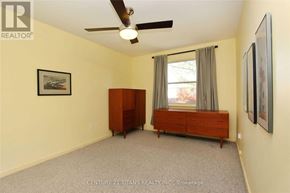 Toronto (Woburn) apartment for rent - A bedroom with a ceiling fan and a window with curtains.