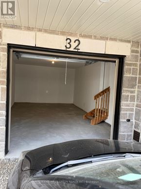 Kitchener townhouse for rent - A car is parked in front of a garage door with the number 32 on it.