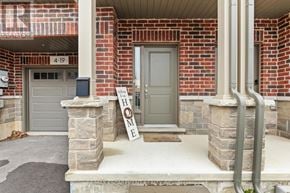 Hamilton (Stoney Creek Mountain) townhouse for rent - A house with a grey door and a sign that says home.