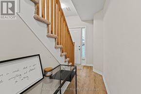 Hamilton (Stoney Creek Mountain) townhouse for rent - A white wall with a framed quote and a wooden staircase.