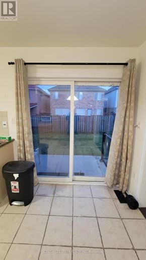 Brampton (Credit Valley) apartment for rent - A black trash bin sits in front of a sliding glass door.