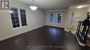 Brampton (Credit Valley) apartment for rent - A room with a wooden floor and a window with a view of a building.