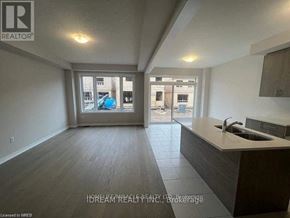 Cambridge apartment for rent - A spacious room with a kitchen area and a view of the outside through a large window.