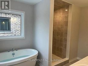 Cambridge apartment for rent - A bathroom with a tub and a walk-in shower.