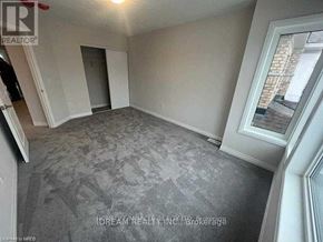 Cambridge apartment for rent - A room with a carpeted floor and a window showing a building outside.
