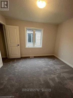 Cambridge apartment for rent - A room with a carpeted floor, a door, and a window.