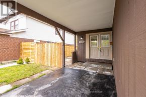 Oshawa (Samac) apartment for rent - A covered outdoor area with a wooden fence and a glass door.