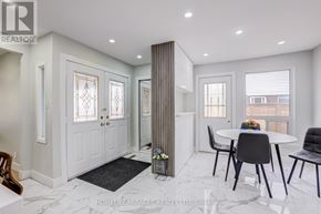Oshawa (Samac) apartment for rent - A white interior of a room with a table and chairs.