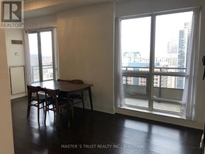 Toronto (Church-Yonge Corridor) condo for rent - A room with a table and chairs in front of a window with a view of the city.
