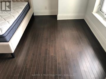 Toronto (Church-Yonge Corridor) condo for rent - A bedroom with a bed and a wooden floor.