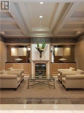 Toronto (Bay Street Corridor) condo for rent - A living room with a fireplace and a glass coffee table.