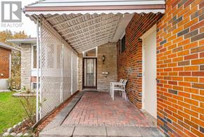 Brampton (Southgate) apartment for rent - A red brick house with a white fence and a covered patio.
