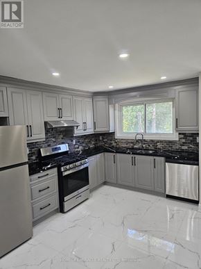 Brampton (Southgate) apartment for rent - A modern kitchen with a black countertop and stainless steel appliances.
