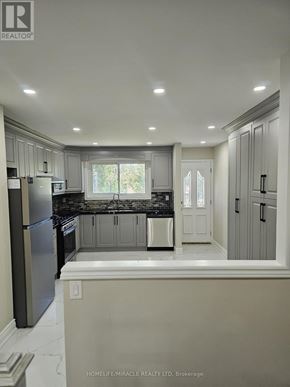 Brampton (Southgate) apartment for rent - A kitchen with a refrigerator, cabinets, and a window.