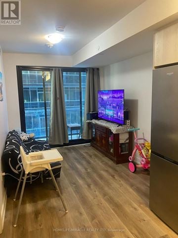 Hamilton (Beasley) condo for rent - A living room with a television and a chair.