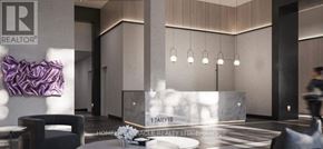 Hamilton (Beasley) condo for rent - A modern lobby with a reception desk and a person walking by.
