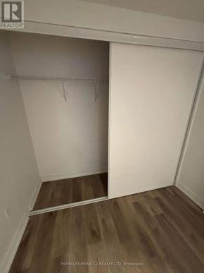 Hamilton (Beasley) condo for rent - A room with a white wall and wooden flooring.