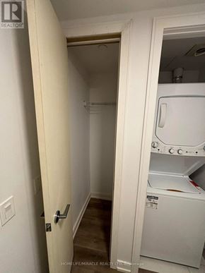 Hamilton (Beasley) condo for rent - A white door opens to a small laundry room with a washer and dryer.
