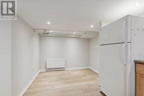 Toronto (Lawrence Park North) apartment for rent - A white refrigerator in a room with wooden floors and white walls.