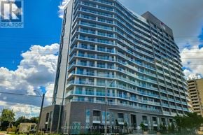 Hamilton (Riverdale) condo for rent - A tall residential building with balconies and a sign that reads "HOMELIFE/MIRACLE REALTY LTD. Brokerage.".