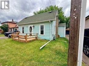 Niagara Falls (Downtown) apartment for rent - A blue house with a porch and a white door.