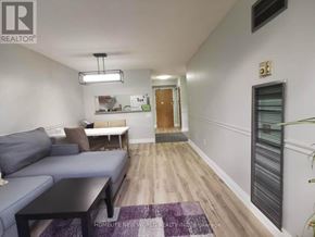 Toronto (Morningside) condo for rent - A living room with a grey couch and a black coffee table.
