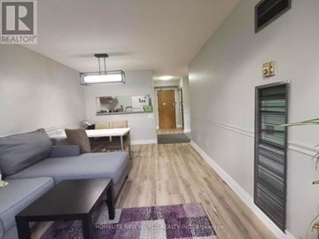 Toronto (Morningside) condo for rent - A living room with a grey couch and a black coffee table.