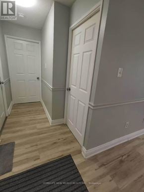 Toronto (Morningside) condo for rent - A hallway with two doors and a mat on the floor.