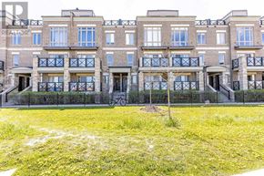 Markham (Cornell) townhouse for rent - A grassy area in front of a building with balconies.