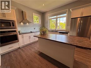 Ancaster apartment for rent - A kitchen with a refrigerator, oven, and microwave.