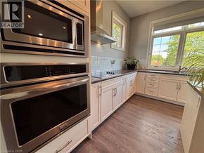 Ancaster apartment for rent - A kitchen with white cabinets and a stainless steel oven.