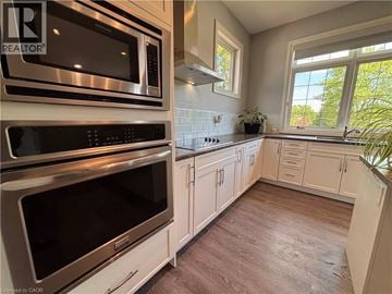 Ancaster apartment for rent - A kitchen with white cabinets and a stainless steel oven.