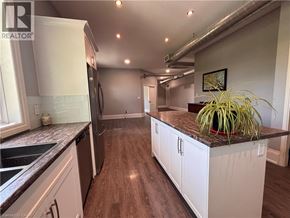 Ancaster apartment for rent - A kitchen with white cabinets and a plant on the counter.