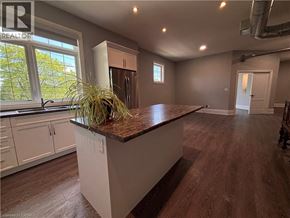 Ancaster apartment for rent - A kitchen with a brown countertop and white cabinets.