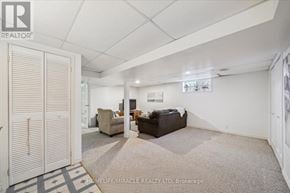 Whitby (Pringle Creek) townhouse for rent - A spacious room with a couch, chair, and a rug in the foreground.